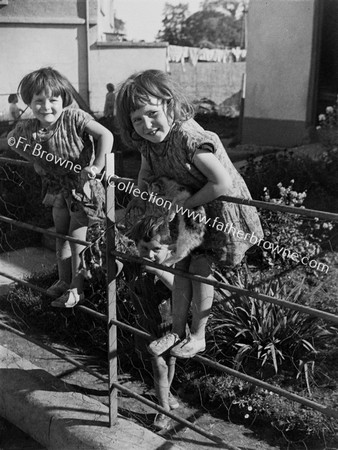 LITTLE GIRLS ON RAILINGS